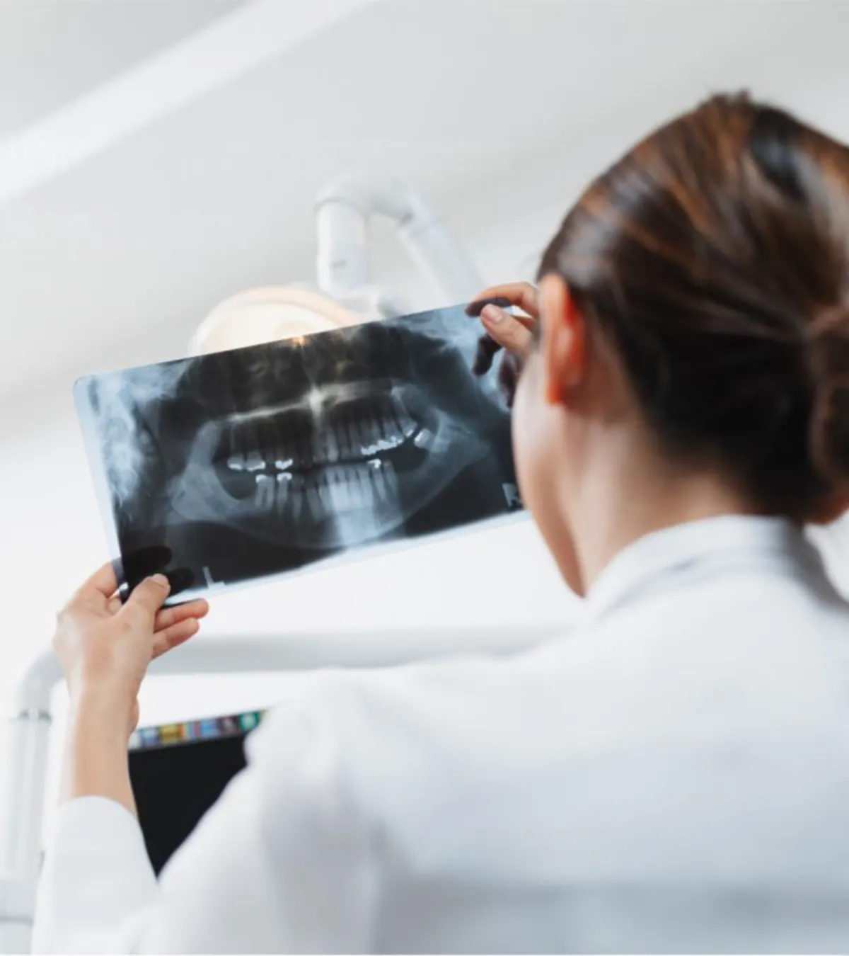Dentist inspecting dental x-ray film